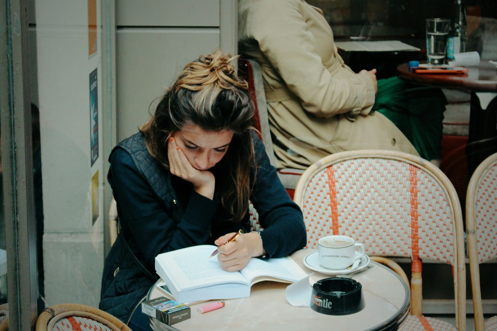 Woman studying intensely at outdoor cafe table
