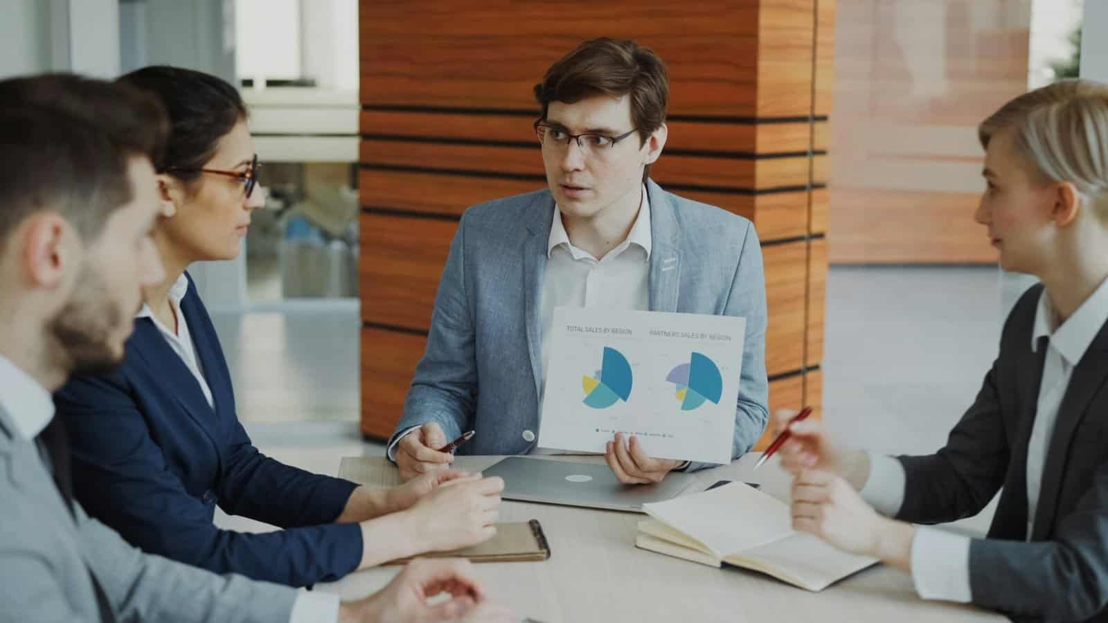 Business meeting with sales data presentation